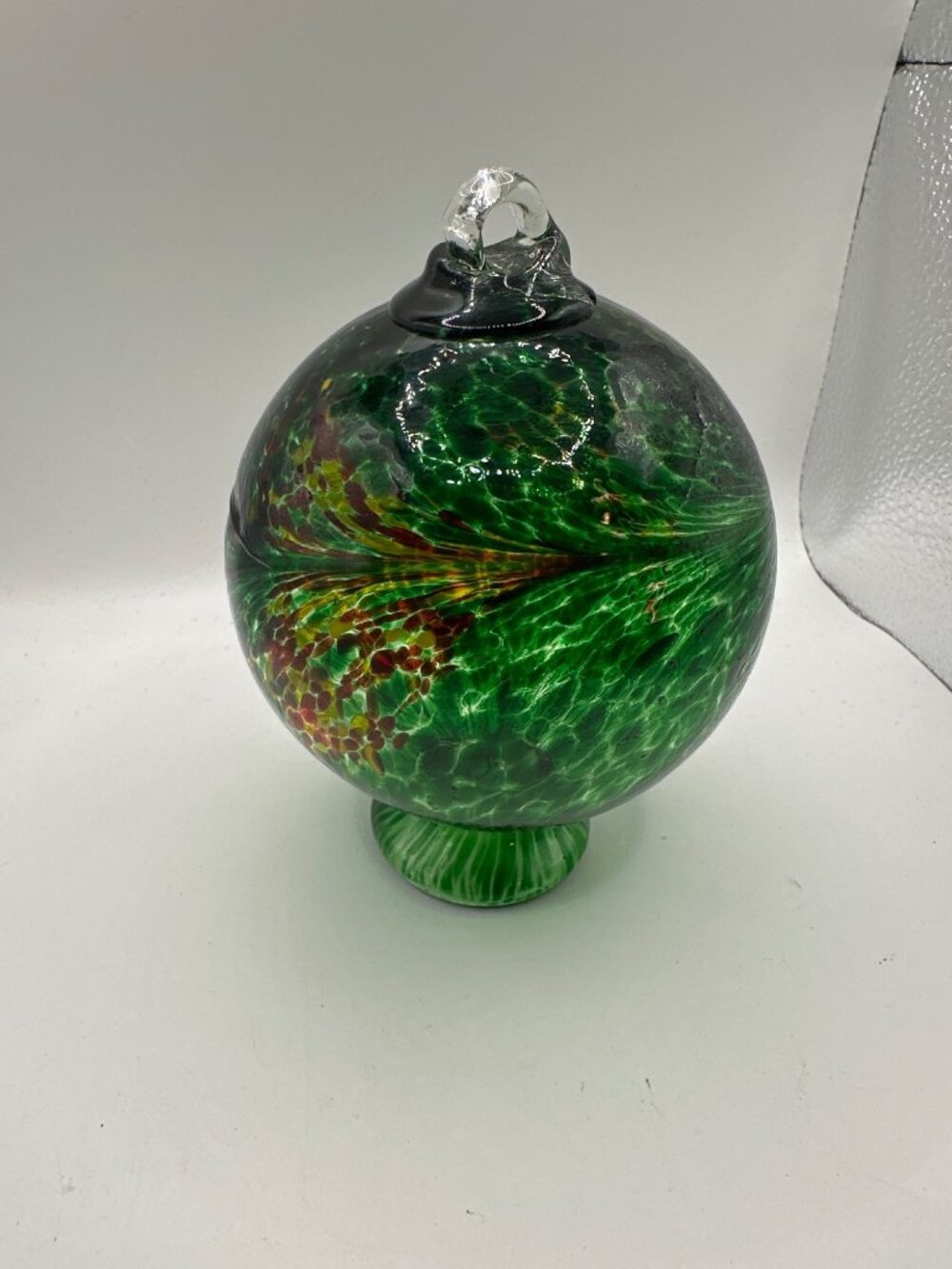 Handblown Green Art Glass Ornament With Red Speckled Accents & Swirl Design